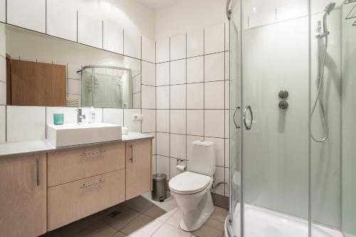 a bathroom with a toilet and a sink and a shower at RVK City centre apartment in Reykjavík