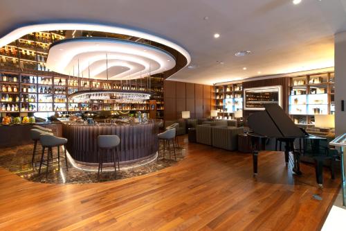 a restaurant with a bar and a piano at SANA Malhoa Hotel in Lisbon