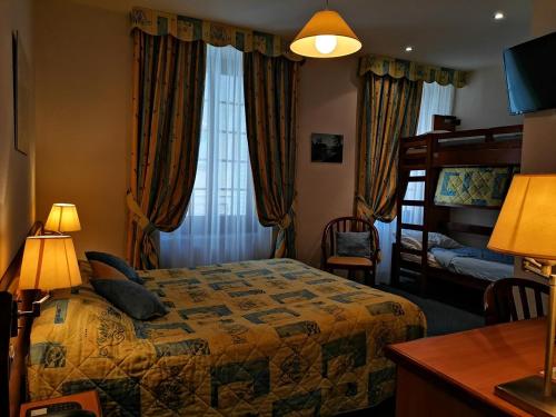 a hotel room with a bed and a window at H&ocirc;tel Saint-Georges in Saint-Jean-de-Maurienne