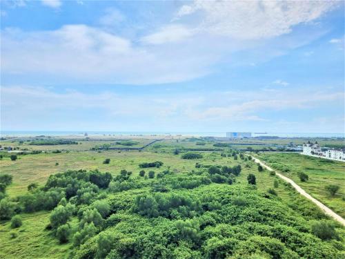 an aerial view of a green field with trees at Spacious 1BR Kingbed Seaview Pool Wifi 8min Jonker Atlantis in Tranquerah
