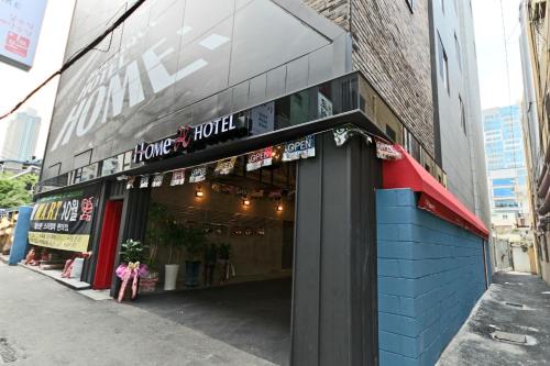 a store front of a building on a city street at Hotel Home in Busan