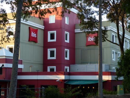 a red building with the bus sign on it at ibis Thornleigh in Thornleigh