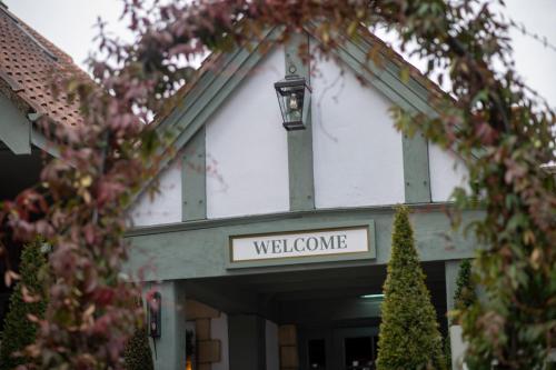 a welcome sign on the front of a building at The Red Lion Inn by Chef & Brewer Collection in Todwick