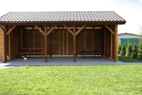 a wooden pavilion with a picnic table in it at Bingo in Powidz
