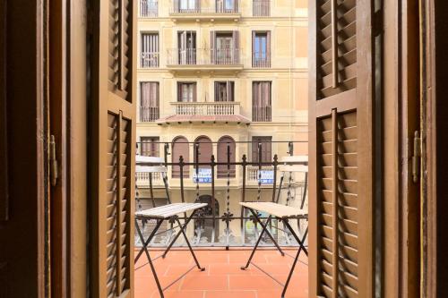 a view of a building from an open window at ApartEasy - Gracia Apartments in Barcelona