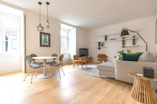 a living room with a table and a couch at Ando Living - Douradores House in Lisbon