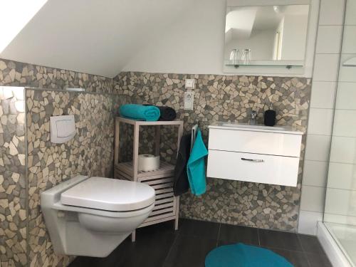 a bathroom with a toilet and a sink at Apartment Maria in Kürten