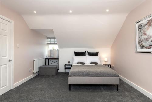 a white bedroom with a bed in a attic at Summer stays for Grain LNG contractors - Apartment D in Gillingham