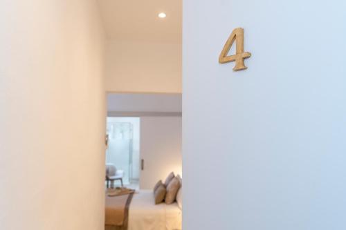 a room with a bed with a number four on the wall at Encant de Alaior Boutique Hotel in Alaior