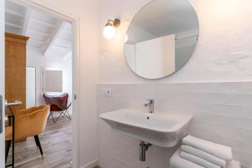 a white bathroom with a sink and a mirror at Encant de Alaior Boutique Hotel in Alaior