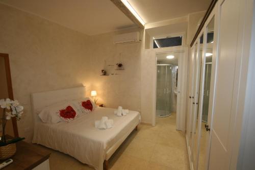 a bedroom with a bed with red roses on it at Colosseum apartment in Rome