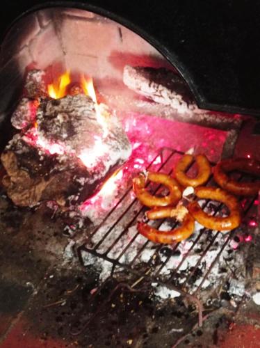 a group of pretzels and meat on a grill at Alojamento local Os Maias in Mirandela