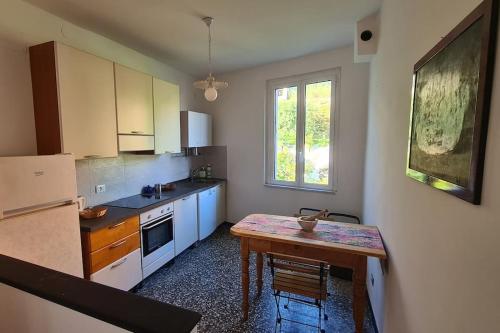 a kitchen with a wooden table and a tableasteryasteryasteryasteryasteryasteryastery at Sea Home above Sori village in Sori