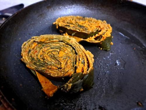 two pieces of food cooking in a pan at Shree Homestay in Manipala