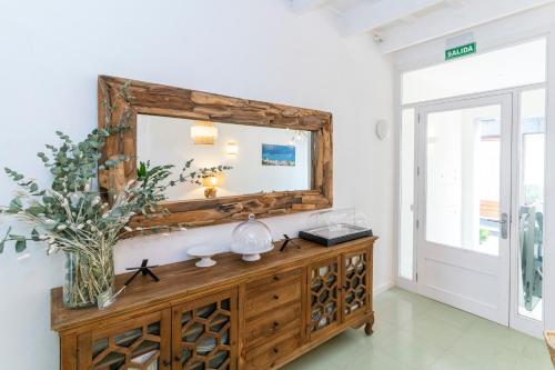 a bathroom with a mirror and a wooden dresser at Encant de Alaior Boutique Hotel in Alaior