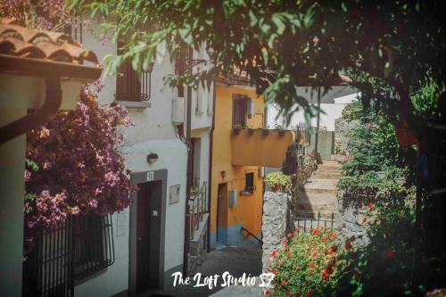 a narrow alley with buildings and flowers and trees at The Loft Studio 57 - VUT.3352AS in Ribadesella