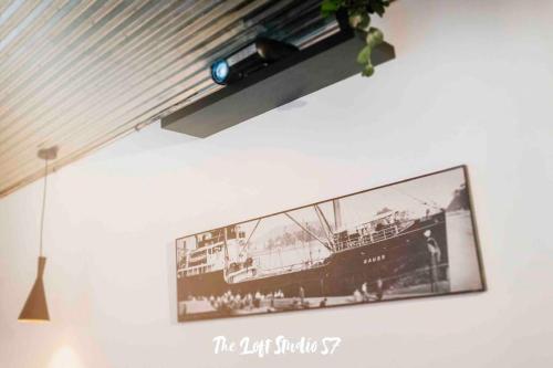 a tv hanging on a wall with a picture of a ship at The Loft Studio 57 - VUT.3352AS in Ribadesella