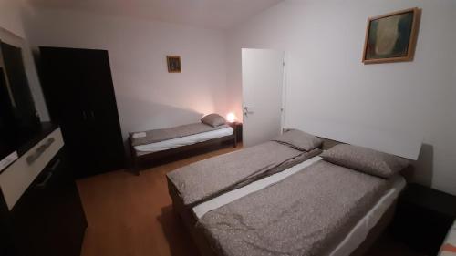 Cette petite chambre comprend deux lits et un canapé. dans l'établissement Apartman TATTOO R, à Negotin