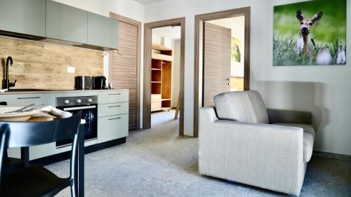 a kitchen with a table and a chair in a kitchen at Case Verdi in Bardonecchia