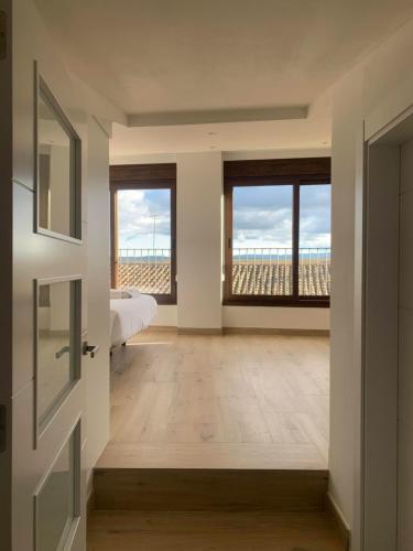 a bedroom with a bed and a view of the ocean at Ca La Rosalia Arbeca in Arbeca