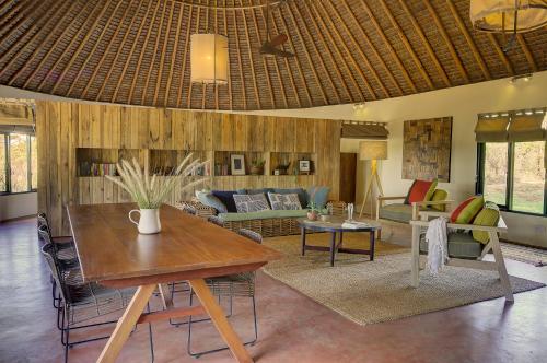 a living room with a table and a couch at Ololo Safari Lodge & Farm in Nairobi
