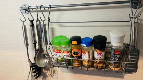 a rack with spices and utensils in a kitchen at Iason Seaview home in Latchi in Polis Chrysochous
