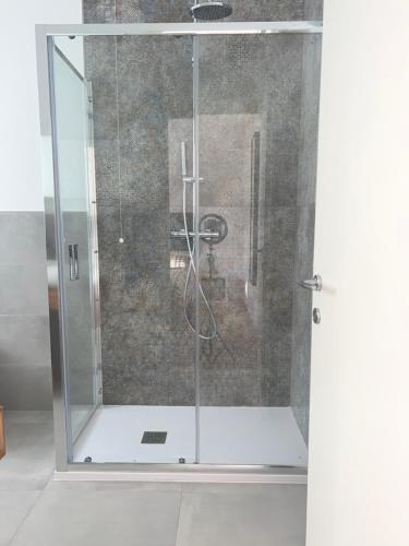 a shower with a glass door in a bathroom at Civico 28 in Pescara