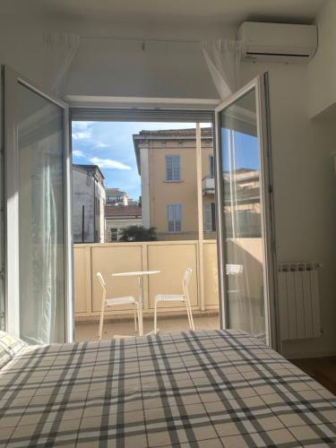 a bedroom with a bed and a balcony with a table and chairs at Civico 28 in Pescara