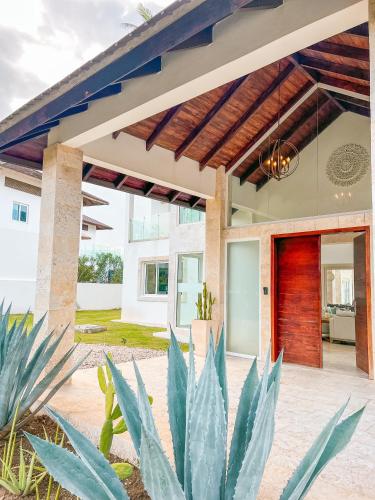a patio with plants in front of a house at Peninsula Esmeralda Luxury Villas in San Felipe de Puerto Plata