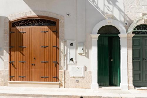two doors on the side of a building at WePuglia - Catarì in Polignano a Mare