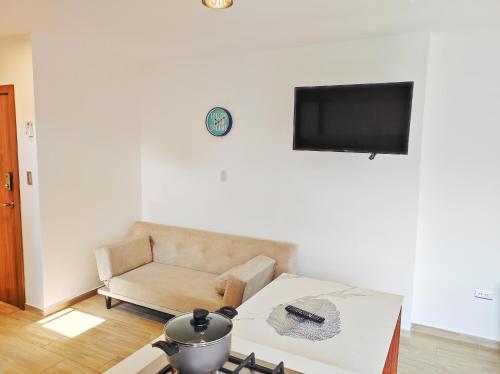 a living room with a couch and a table at Pacific Suites Guayaquil Airport in Guayaquil