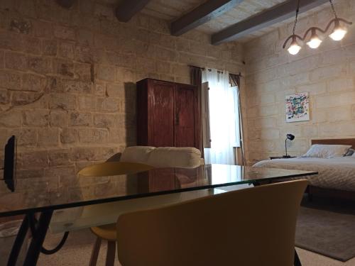 a living room with a dining table and a bedroom at Beautiful Studio apartment in Qormi Malta in Qormi