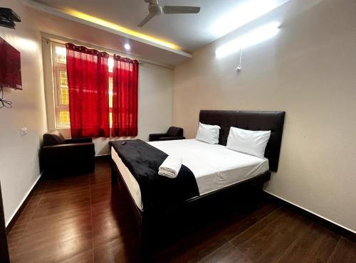 a bedroom with a bed and a red window at I Care With Greenery Comforts in Devanahalli-Bangalore
