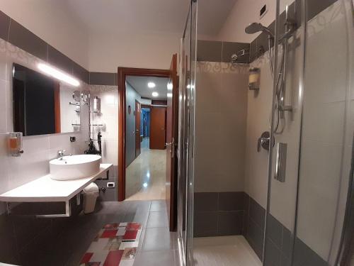 a bathroom with a sink and a shower at BIKE HOUSE 2 "evo" in Seriate