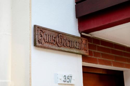 a wooden sign on the side of a building at Haus Germania in Helgoland
