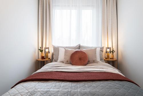 a bedroom with a large bed with a window at Apartament Chopin - ścisłe centrum - by Kairos Apartments in Gliwice