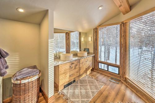 a bathroom with two sinks and a large window at Life on Easy Street with Hot Tub 7 Mi to Dwtn! in Hailey