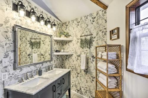a bathroom with a sink and a mirror at Picturesque Cottage in the Heart of Trenton! in Trenton
