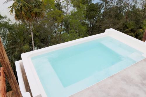 a large swimming pool sitting on a patio at Casa Marivan, Private Pier, Free Paddle Boards & Kayac in Bacalar