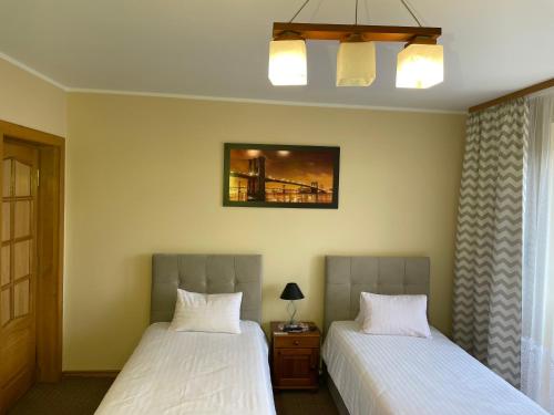 a bedroom with two beds and a bridge at Zajazd nad Sanem in Jarosław