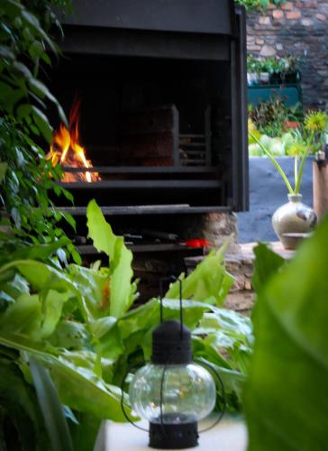 a fireplace in a garden with a fire place at EXQUISITE PRIVATE LUXURY SUITE WITH KING BED at BOKMAKIERIE VILLAS in Windhoek