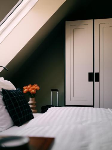 a bedroom with a white bed with a black wall at WELTWIEN Luxury Art Apartments & Free Parking in Vienna