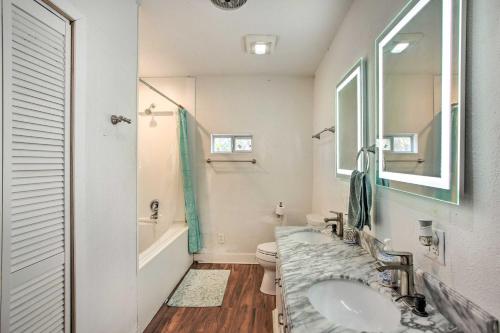 a bathroom with a sink and a toilet and a mirror at Deck, Grill and Yard Pet-Friendly Van Alstyne Gem! in Van Alstyne
