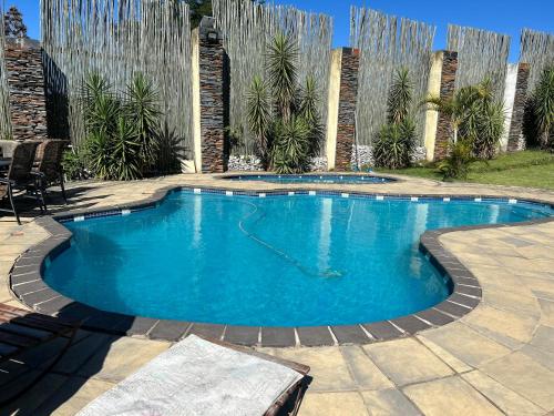 a swimming pool in a backyard with a fountain at Mihandzu Guest House in Hazyview