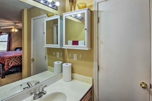 a bathroom with a sink and a mirror at Central Kansas City Home Less Than 3 Mi to Downtown! in Kansas City
