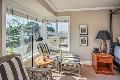 a living room with chairs and a table and a window at Cannon Beach Hotel Collection in Cannon Beach
