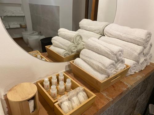 a pile of towels on a counter in front of a mirror at Il Rustico in Sansepolcro