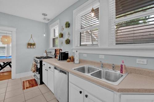 a kitchen with a sink and a stove at Cheerful Midtown home with view of Rhodes College in Memphis
