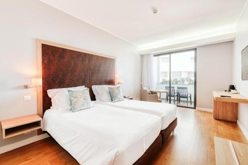 Кровать или кровати в номере Vila Baleira Funchal