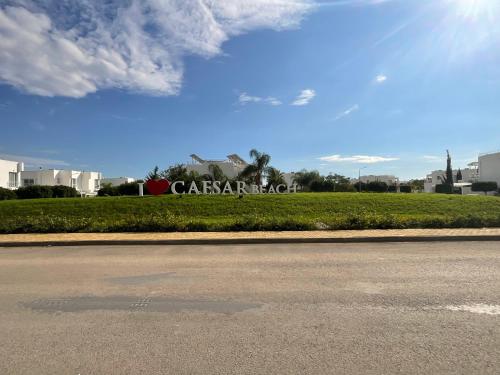 a sign for a car dealership on the side of a road at The Best Apartment on the beach 'Caesar Beach' Bogaz, North Cyprus in Boğaz